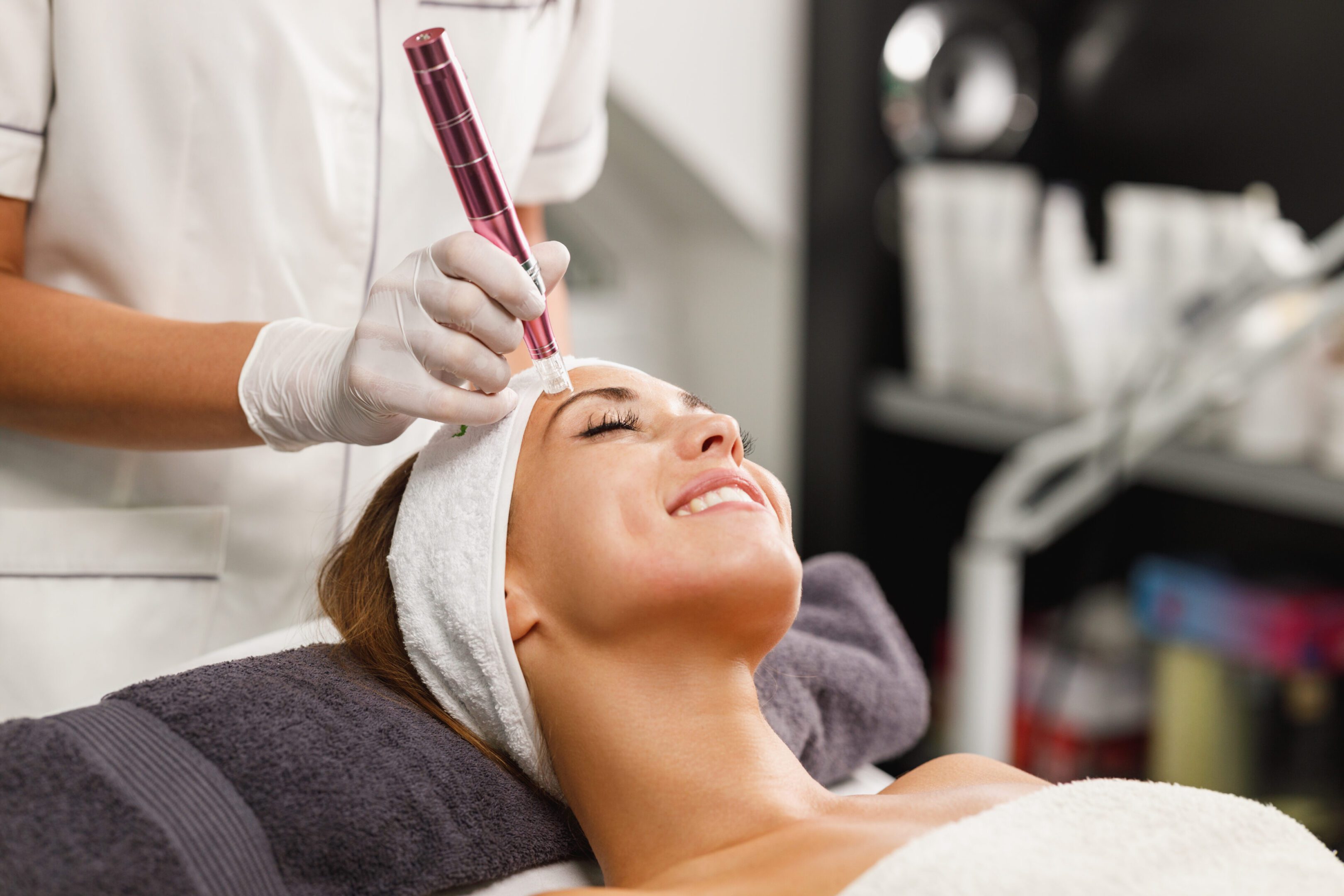 A woman getting her face waxed at the spa